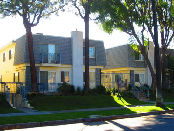 Front view of a two-story building with balconies and a gable roof.