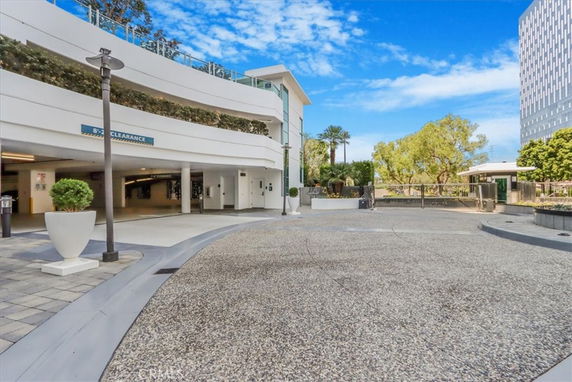 Outdoor parking area with multi-level parking structure.
