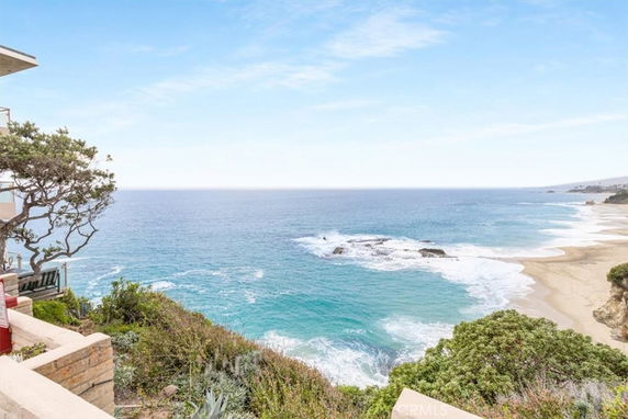 Panoramic view of the ocean and beach from a cliffside home.