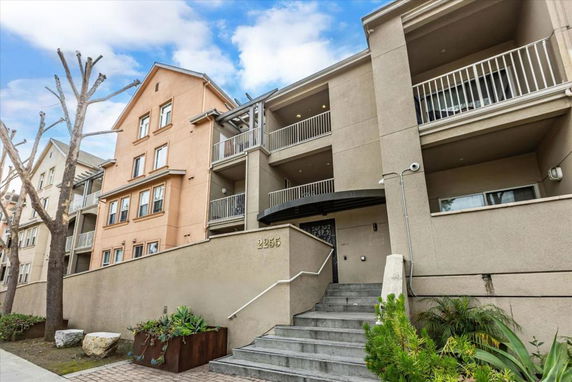 Front view of a multi-story residential building with balconies.
