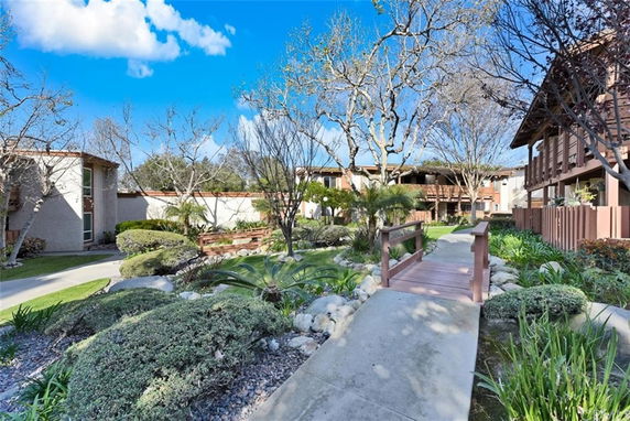 Front view of multiple residential buildings with landscaped pathways and garden areas.