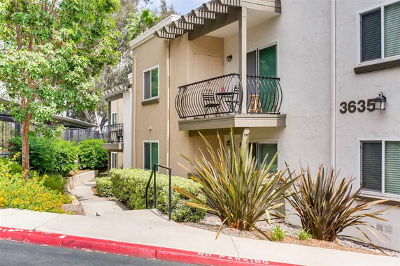 Front view of a multi-story residential building with balconies.