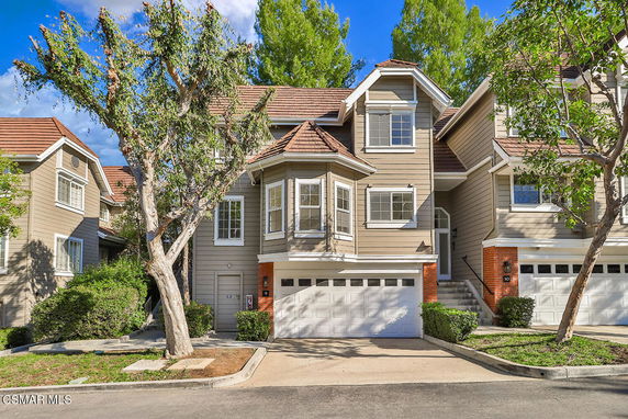 Front view of a multi-story house with a double garage.