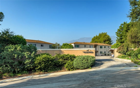 Front view of a two-story building with a flat roof and a driveway.