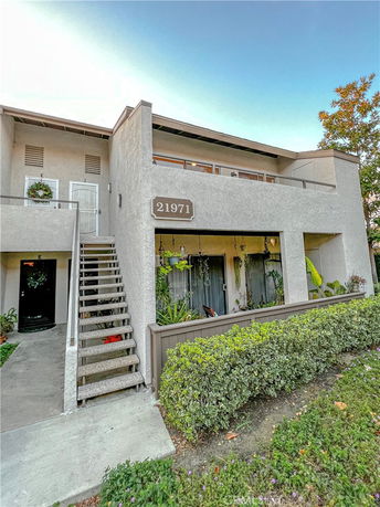 Front view of a two-story building with an external staircase.