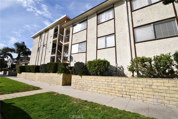 View of a multi-story residential building with a brick facade.