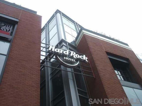 Front view of a hotel building with a large sign.