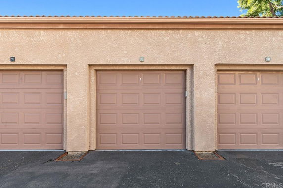 View of a row of garage doors in a parking area.