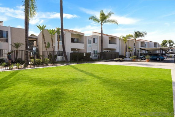 Front view of an apartment complex with two-story buildings and balconies.