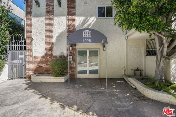 Front view of a building entrance with a canopy labeled 1228.
