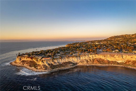 Aerial panoramic view of a coastal residential area on a cliff overlooking the ocean.