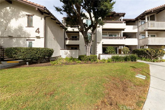Front view of a multi-story residential building with multiple balconies.