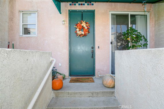 Front entrance of a single-story house with a decorative wreath on the door.