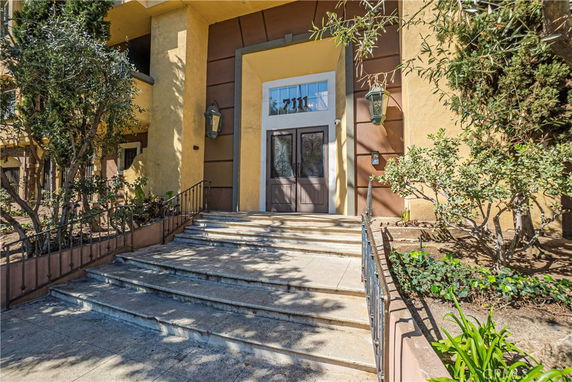 Entrance view of a building with steps leading to a door.