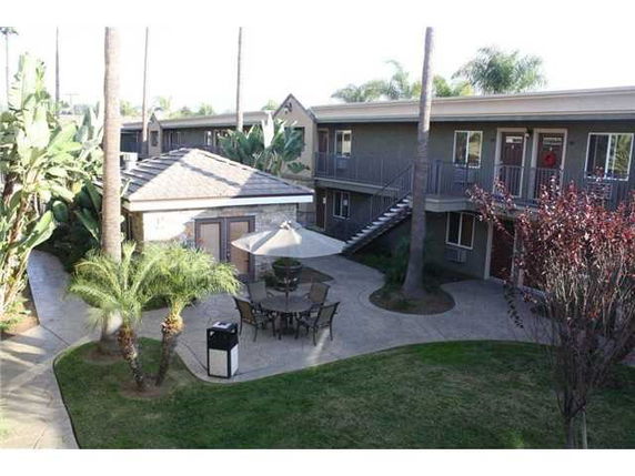 View of a courtyard area with outdoor seating and surrounding buildings.