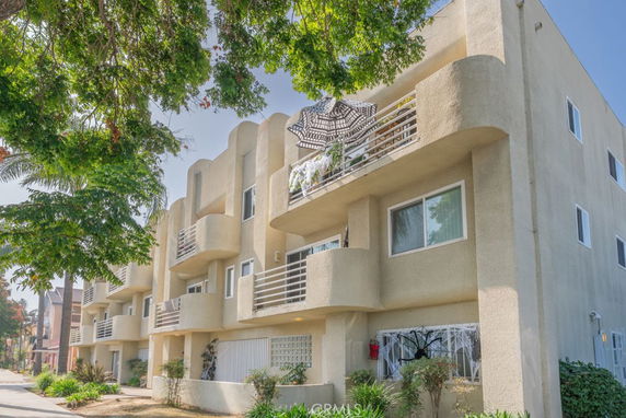 Front view of a multi-story apartment building with balconies.
