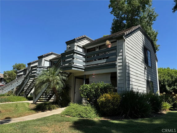 Front view of a multi-story building with exterior stairs and balconies.