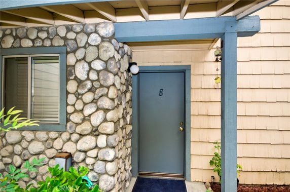 Entrance to a house with stone and wood exterior.