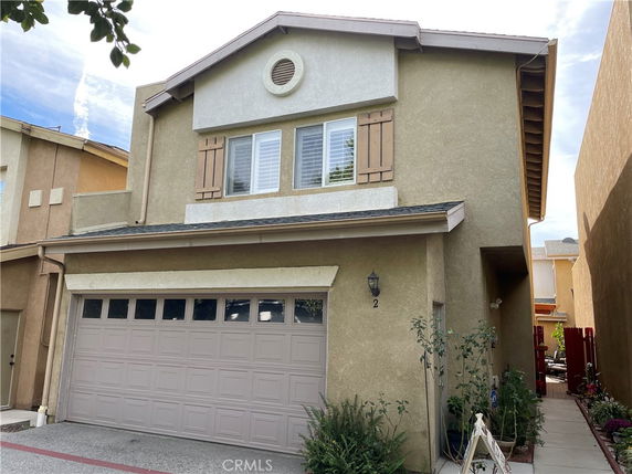 Front view of a two-story house with a double garage.
