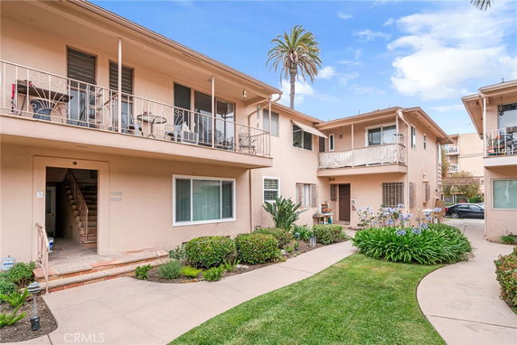 Front view of a two-story apartment complex with a courtyard.