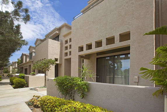 Front view of a modern multi-story residential building with unique architectural design.