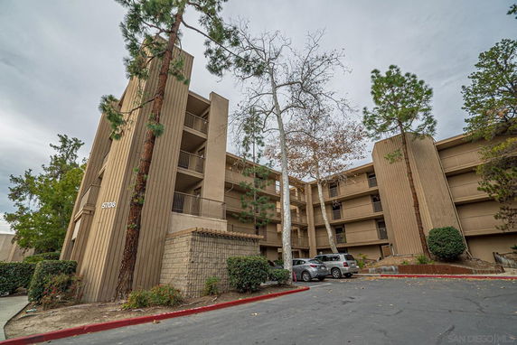 Front view of a multi-story apartment building with balconies.