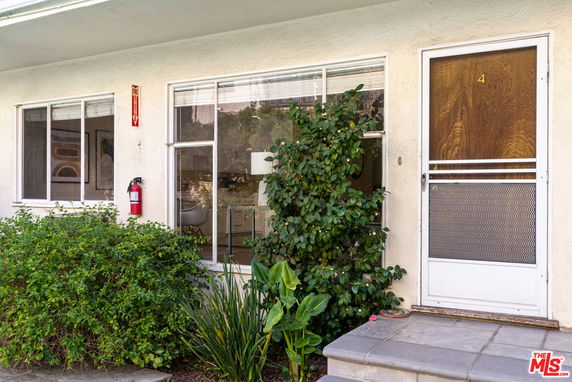 Front view of a building with windows and a door.