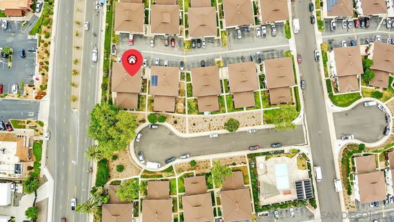 Aerial view of a residential area with multiple houses and parking spaces.
