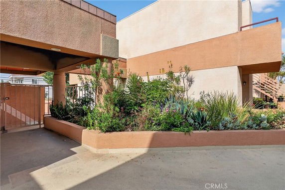 Front view of a building with a modern design and landscaped plants.