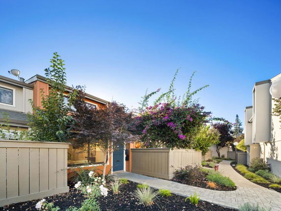 Front view of a two-story house with a garden path.