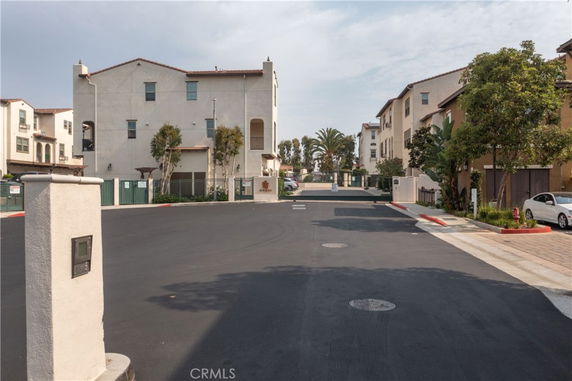 Front view of three-story residential buildings in a gated community.
