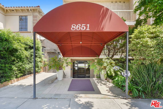 Front view of a building entrance with a red canopy labeled 8651.