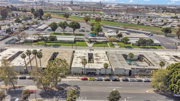 Wide angle view of a building complex with multiple rooftops and surrounding areas.