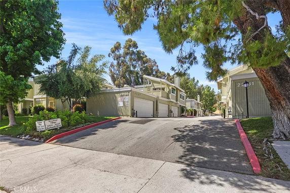 Front view of residential buildings with garages in a neighborhood.