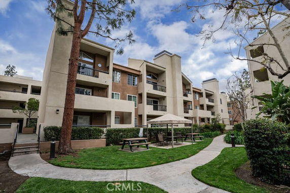 Front view of a multi-story apartment building with balconies.