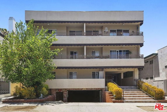 Front view of a multi-story residential building with balconies.