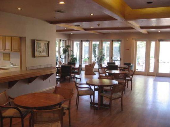 Indoor recreation area with tables and chairs for social gatherings.