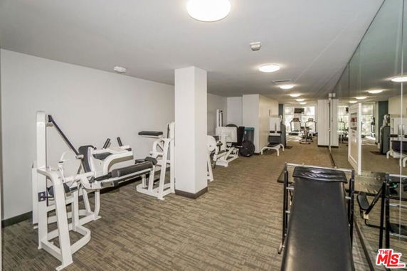 Interior view of a fitness room with various gym equipment.