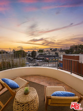 Panoramic view from a building balcony at sunset.