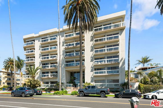 Front view of a multi-story residential building with balconies.
