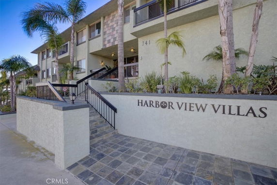 Front view of a multi-story building named Harbor View Villas.