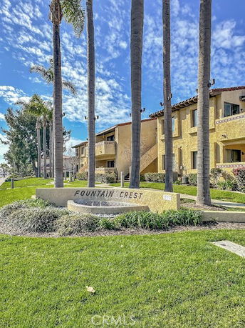 Front view of a multi-story building with a sign reading 'Fountain Crest'.