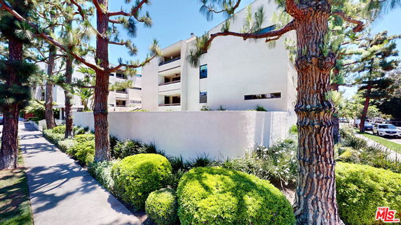 Front view of a multi-story residential building with a simple modern design.