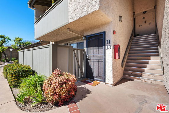 Front view of a multi-unit building with stairs leading to upper units.