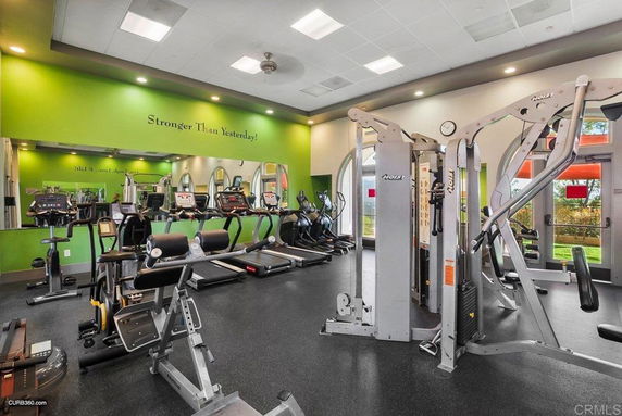 Indoor gym area with various exercise equipment.
