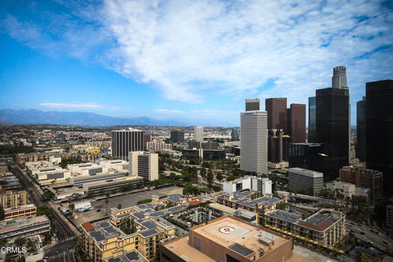 Wide-angle view of a cityscape with multiple skyscrapers and surrounding buildings.