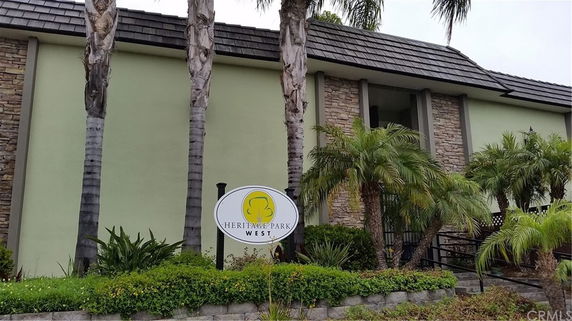 Front view of a building with stone accents and a sign reading 'Heritage Park West'.