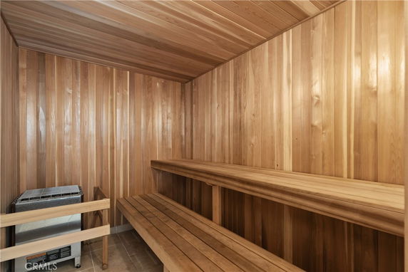 Interior view of a wooden sauna with benches.