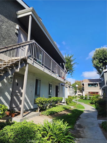 Front view of a two-story apartment building with balconies.