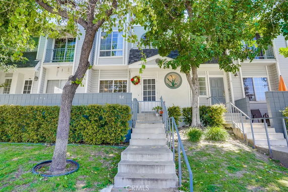 Front view of a townhouse with steps leading up to the entrance.